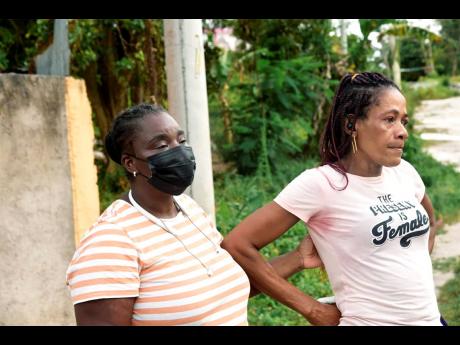 Janice Solomon (right) is consoled by Beverly Wedderburn, a community leader and justice of the peace in Salt Spring.