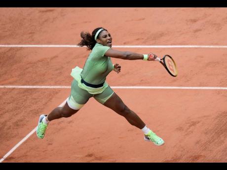 Serena Williams serves to Romania’s Mihaela Buzarnescu during their second round match on day four of the French Open tennis tournament at Roland Garros in Paris, France, yesterday.
