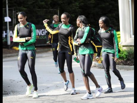 Several Jamaican athletes walk together after a training session at  Jamaica’s pre-Olympics camp at the University of Birmingham ahead of the London 2012 Olympic Games on Tuesday, July 25, 2012. From left are: Kaliese Spencer, Christine Day, Shericka Wil