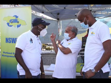 Winston Maragh (centre), mayor of May Pen and chairman of the Clarendon Municipal Corporation, makes a point to Audley Gordon (left), executive director, National Solid Waste Management Authority (NSWMA), and Edward Muir, regional operations manager, SPM W