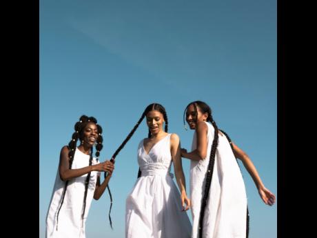 From left: Aalyiah Heath, Sofia Coupellier and Chloe Etienne having a little fun in the field in a photograph for Rebecca Rowe’s capstone project. 