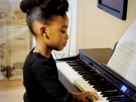 The sixth-grader is being taught to play the piano and other instruments. 