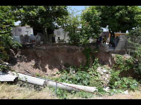 Photos by Ian Allen/Photographer 
An asbestos pipe runs through a section of a poorly constructed gully that has eroded during heavy rains in 2020 and damaged houses along Harbour Drive in Harbour View, St Andrew.