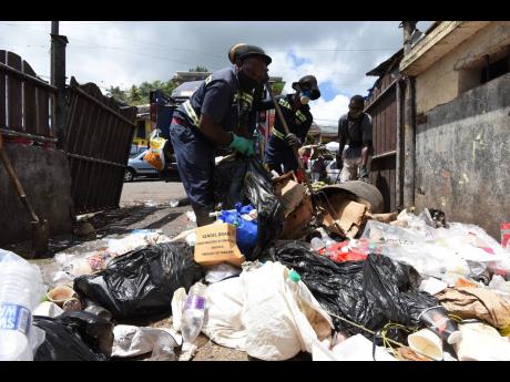 A work crew collecting garbage from the Brown’s Town Market.