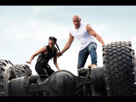 This image released by Universal Pictures shows Nathalie Emmanuel (left), and Vin Diesel in a scene from ‘F9’. 