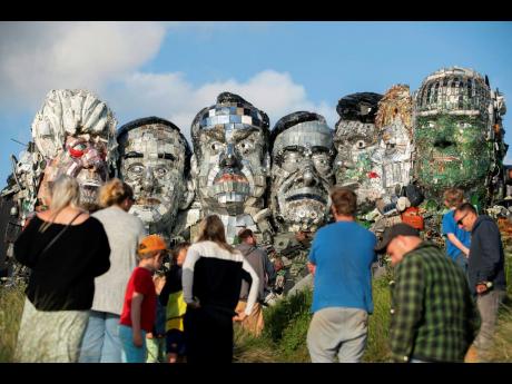 People look at artwork called Mount Recyclemore.