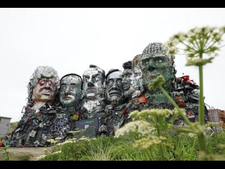 A sculpture created out of e-waste in the likeness of Mount Rushmore and the G7 leaders on a hill in Hayle, Cornwall, England.