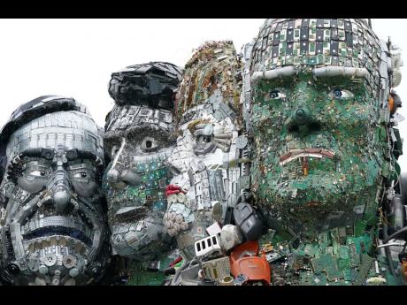 A sculpture created out of e-waste in the likeness of Mount Rushmore and the G7 leaders stands on a hill in Hayle, Cornwall, England, Wednesday, June 9, 2021. The sculpture, created by British artist Joe Rush ad sculptor Alex Wreckage, named Mount Recyclem