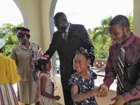 Elder at Asia Seventh-day Adventist Church Errol Isaacs (centre) greets members of the church and the police force  at a special service just before the pandemic in 2020.