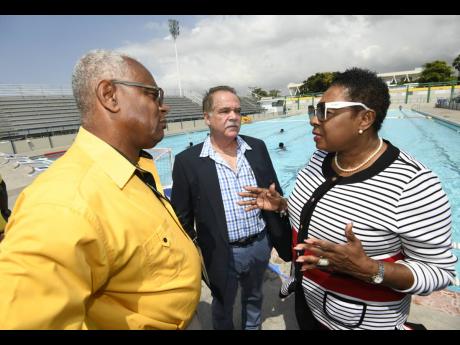 Minister of Sport Olivia Grange with Major Desmon Brown (left), general manager, Independence Park Limited, and Martin Lyn, president of the Aquatic Sports Association of Jamaica, at the National Aquatic Centre.