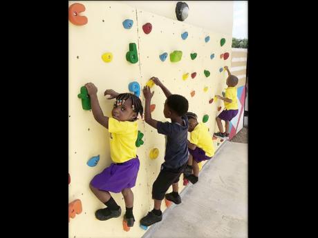 It’s rock climbing time for students of the Savanna-la-Mar Inclusive Infant Academy.