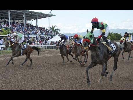 File
Jockey Oneil Foster rides MEET JUSTIN to victory in the Little Caesars Hot ‘N’ Ready Run trophy on The Burger King Superstakes Raceday at Caymanas Park on Saturday, November 10, 2018. 