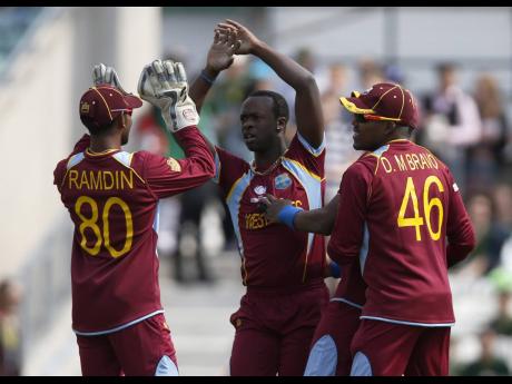 West Indies’ players celebrate the wicket of Pakistan’s Imran Farhat during their ICC Champions Trophy Group B match at the Oval cricket ground, London, in June 2013. 