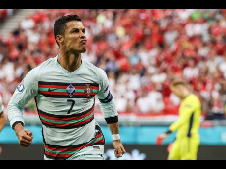 Portugal’s Cristiano Ronaldo celebrates after scoring his second team goal during the Euro 2020 championship group F match between Hungary and Portugal at the Ferenc Puskas stadium in Budapest, Hungary, yesterday. Portugal won 3-0.