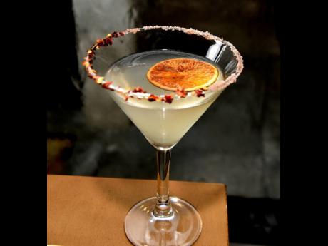 below: Spicy Karai is a smooth martini made with Patron Repasado, Grand Marnier, a sour mix and is topped with pink Himalayas salts and peppers to give you a two-in-one experience.