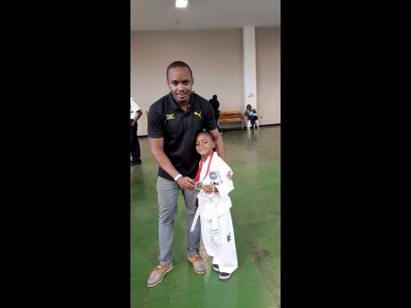 Kamal Powell (left), and his son, Marcus, following a karate tournament. 