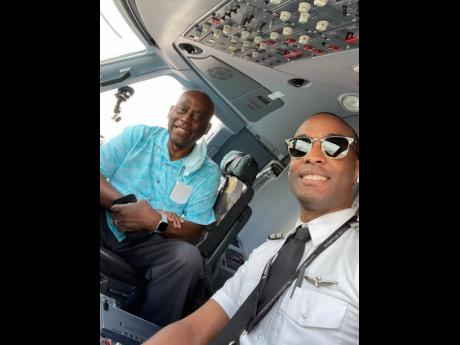
American Eagle Captain Anselm Dewar and his dad Ashman in the cockpit on a recent flight between Florida and South Carolina, United States.