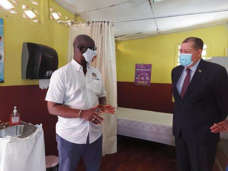 Minister of Local Government and Community  Development Desmond McKenzie (left), along with Member of Parliament for North East Manchester Audley Shaw visit the isolation area of the hurricane shelter at the Christiana Primary School last Friday.