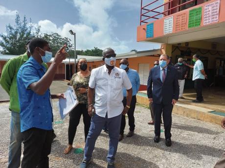 From left: Acting Parish Disaster Coordinator at the Manchester Municipal Corporation Keval Lewis, Minister of Local Government and Community Development Desmond McKenzie, and Member of Parliament for Manchester North East Audley Shaw, along with other off