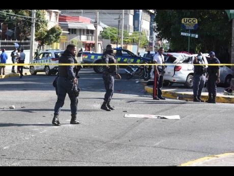 Left: Policemen cordon the intersection of North Street and South Camp Road, the site of a February 17 crash that killed one person and severely injured Trishauna Blair.