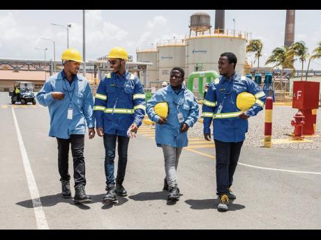 From left: University of Technology, Jamaica engineering students Tajay Daley, John-Daniel Martin, and Travis Patterson, along with O’Brian Simpson from the Caribbean Maritime University, are on cloud nine over their internship at New Forest Energy’s C