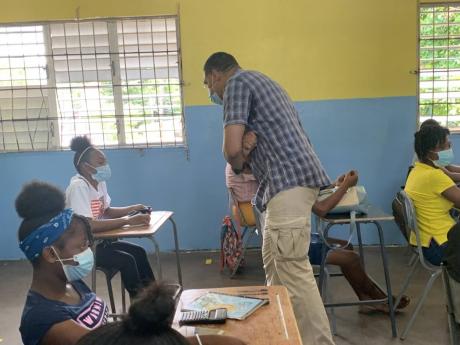 Prime Minister Andrew Holness interacts with students of Penwood High School