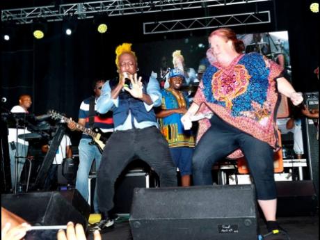 Elephant Man tries not to be upstaged by a patron who joined him on stage at the 2019 jerk festival.