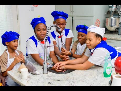 Students of the Lannaman’s Preparatory School, a Nestle For Healthier Kids (N4HK) participating school, demonstrates one of the N4HK healthy habits: washing of hands.
