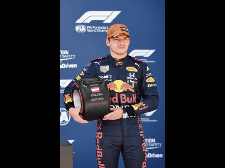 
First place for pole position, Red Bull driver Max Verstappen of the Netherlands holds his prize after the qualifying session ahead of the Austrian Formula One Grand Prix at the Red Bull Ring racetrack in Spielberg, Austria, yesterday. The Austrian Grand 