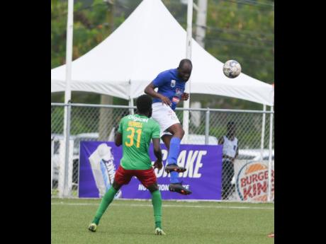 
Mount Pleasant’s Francois Swaby heads the ball while Hugh Howell of Humble Lion looks on in the Humble Lion versus Mount Pleasant Jamaica Premier League fixture held at the UWI/JFF/Capt Horace Burrell Centre of Excellence in St Andrew yesterday. Mount P