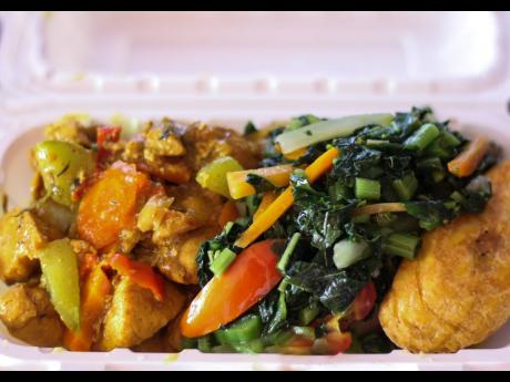 A neatly boxed meal of curried chicken, steamed callaloo on top of boiled food with a side of fried ripe plantain would satisfy any Jamaican breakfast craving. 