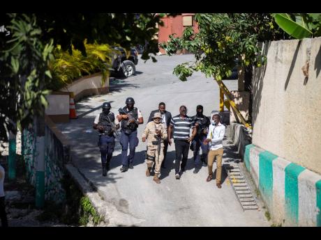 Security forces investigate the perimeters of the residence of Haitian President Jovenel Moise, in Port-au-Prince, Haiti yesterday. 