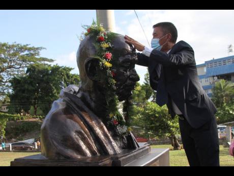 Rungsung Masakui, India’s high commissioner to Jamaica, participates in the unveiling of a bust of Mahatma Gandhi in May Pen, Clarendon, on Wednesday.