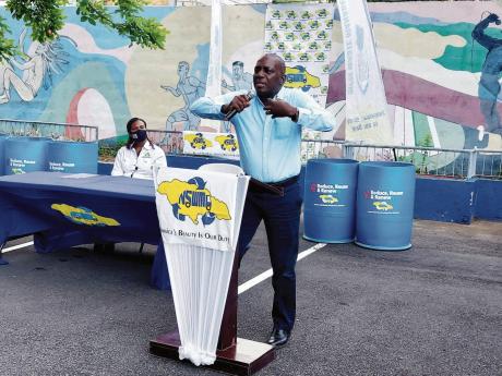 Executive Director of the NSWMA Audley Gordon addresses a gathering in Jones Town on Tuesday.