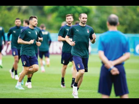 
Italy’s Giorgio Chiellini (front) runs during a training session at Tottenham Hotspur training ground in London, England yesterday, ahead of their Euro 2020 final against England at Wembley Stadium this afternoon. 