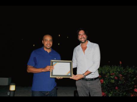 Area commercial director, AMResorts, Fernando Garcia (right), presents a certificate to top-producing agent, Kareem Lewis – KML Enterprise.