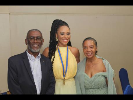 The new Rotary Club of Mandeville president, Dr Kimberly Freeman, flanked by her parents Linval (left) and Donna Freeman.