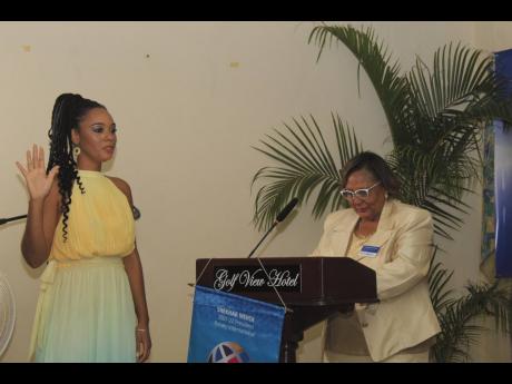 Dr Kimberly Freeman (left) takes the oath of office as the 58th president of the Rotary Club of Mandeville, being administered by Assistant Governor Marcelle Fenton.