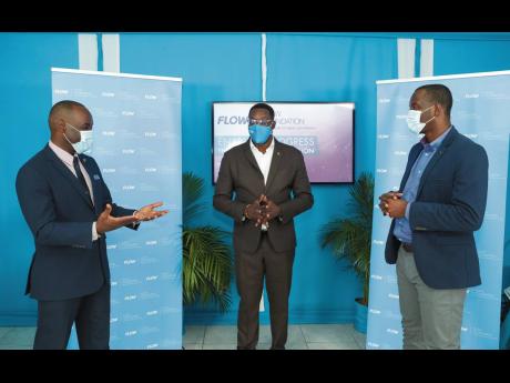 Jasford Gabriel (left), president, Jamaica Teachers’ Association (JTA), discusses the next steps with Stephen Price (centre), chairman, FLOW Foundation, and Ricardo Allen (right), president and CEO,One-on-One Educational Services, during a light moment a