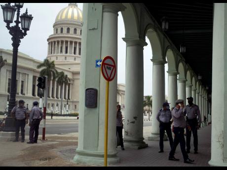 
Police stand guard near the National Capitol building in Havana, Cuba, on Wednesday, July 14, 2021, days after street protests. 