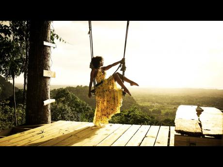 This woman relaxes on a swing at Campbelton Mountain Adventures. 