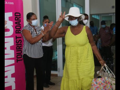 Tourism officials welcome a traveller at the Sangster International Airport in Montego Bay, St James.