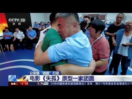 Guo Gangtang (right), embraces his long lost son, Guo Xinzhen, during a reunion after 24 years in Liaocheng in Central China’s Shandong province on Sunday. Guo was abducted as a toddler outside their home.