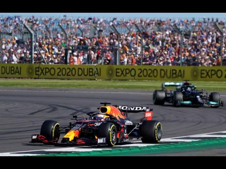 
Red Bull driver Max Verstappen of the Netherlands pulls away from Mercedes driver Lewis Hamilton of Britain during the Sprint Qualifying of the British Formula One Grand Prix, at the Silverstone circuit in Silverstone, England, yesterday.
