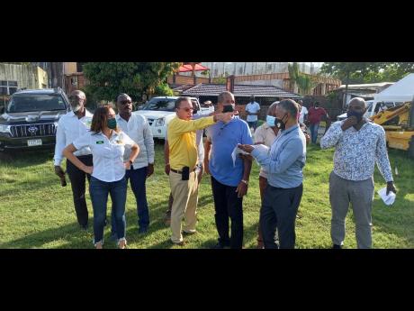 West Portland MP Daryl Vaz points the site where a transport centre is proposed to be built on a property owned by the Jamaica Railway Corporation in Boundbrook, Portland.