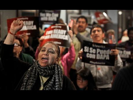 In this Tuesday, February 17, 2015, photo, Mercedes Herrera and others chant during an event on DACA and DAPA Immigration Relief at the Houston International Trade Center. A federal judge in Texas ordered, on July 16, an end to an Obama-era programme that 