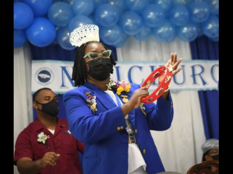 Patsy Edwards-Henry, president of the Nurses Association of Jamaica, rattles a tambourine during praise and worship at the Nurses Week church service held at Mary Seacole House in Kingston on Sunday.