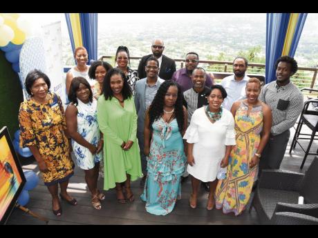 Marie Powell (left), assistant governor for Rotary clubs, Jamaica South-West, shares the moment with the newly installed board of young professionals of the Rotary Club of Trafalgar New Heights in St Andrew, led by Dr Suzanne McDonald Fowles (third left). 