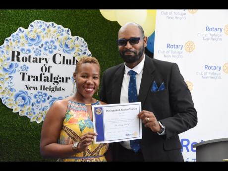 Attorney-at-law Franchesca Francis, past secretary, Rotary Club of Trafalgar New Heights, was named Rotarian of the Year for 2020-2021 for her commitment and perseverance during the pandemic year. Presenting her certificate is president for the 2020-2021 R