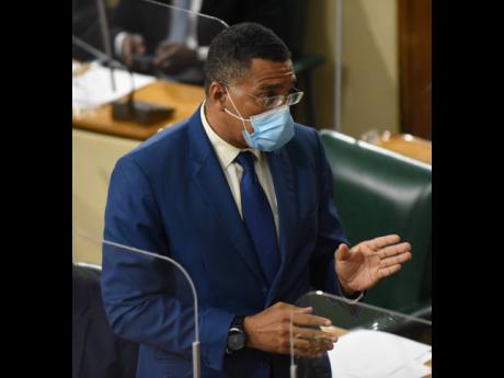 Prime Minister Andrew Holness addresses lawmakers in the House of Representatives on Tuesday.